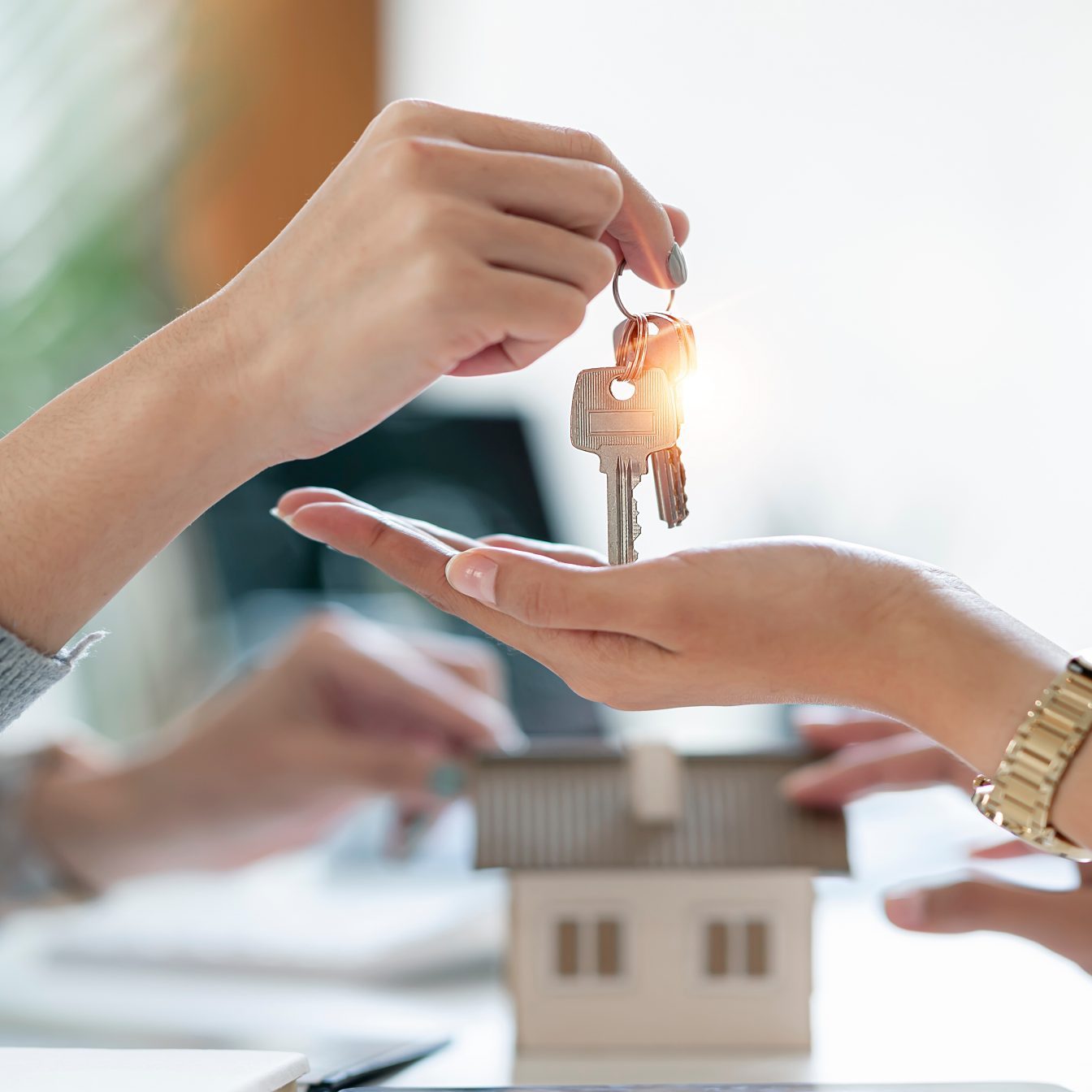 Idaho real estate agent giving house key to her new home buyer, property, real estate concept